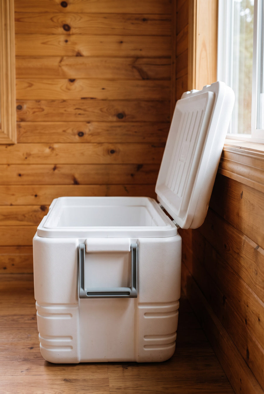 Lid hits the wall. Forces you to pull the cooler away from the wall to fully open.